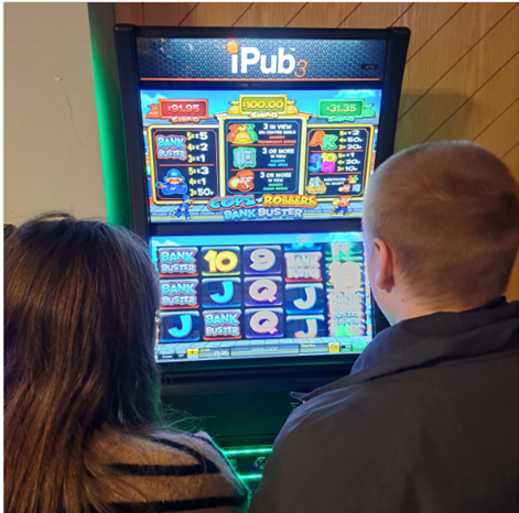 Derbyshire police cadets playing pub gaming machine.